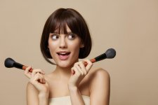 44187570_portrait-woman-makeup-brushes-in-hand-model-makeup-posing-isolated-background.jpg